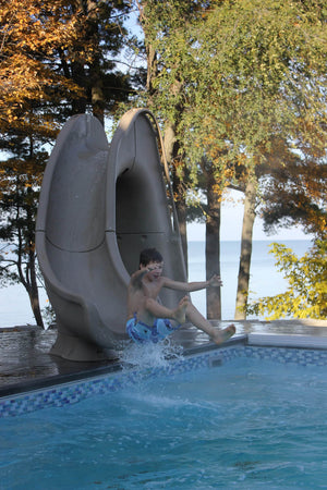 Global Pool Products Tidal Wave pool slide installed on a pool deck