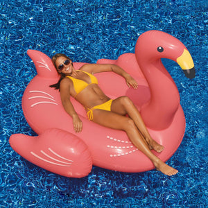Swimline Giant Pink Flamingo Float - swimmer reclining on the ride-on flamingo in a pool