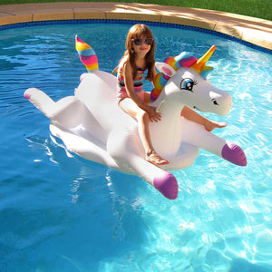 Blue Wave Cloud Rider Rainbow Unicorn Pool Float - child seated on the float, seen from the front