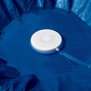 Blue Wave Winter Pool Cover Drain - perforated drain disc sitting in standing water on a cover
