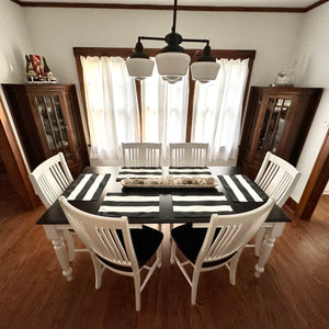 Island Retreat Outdoor Table Mat Set - striped mats and runner laid on a dark dining table