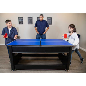 Hathaway Triple Threat Multi-Game Table - three people playing table tennis on the fitted top