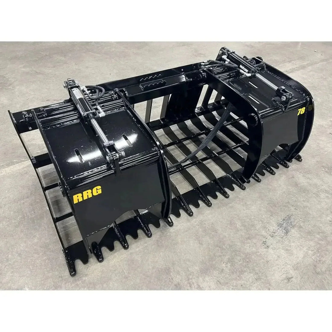 Root grapple vs brush grapple — Stinger root and rock grapple with open tines on a loader