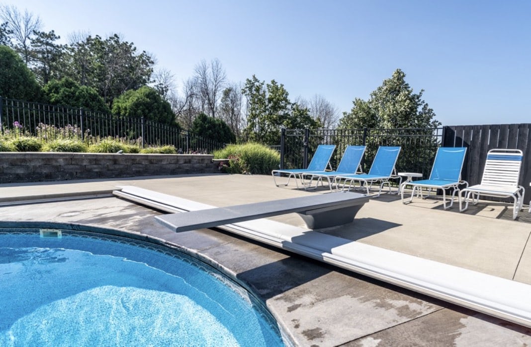Global Pool Products GX diving board installed at a backyard pool