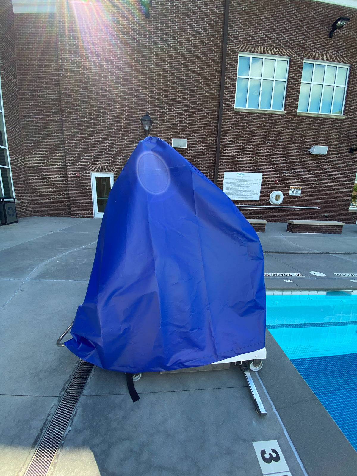 Spectrum Aquatics portable pool lift cover — cover fitted on a portable lift