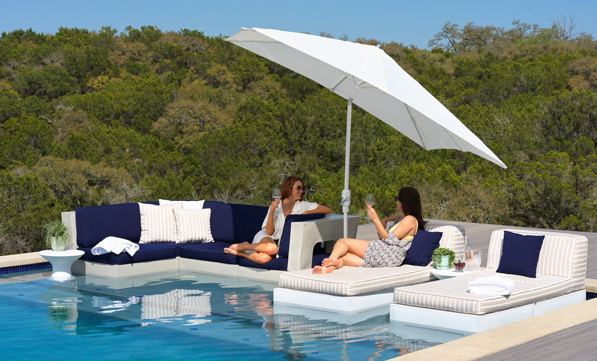 Ledge Lounger Affinity 2 Piece Sun Chair in a poolside setting under umbrellas