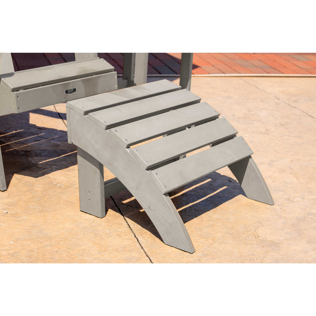 Island Retreat Adirondack Ottoman, Slate Grey - curved slatted footrest on a patio