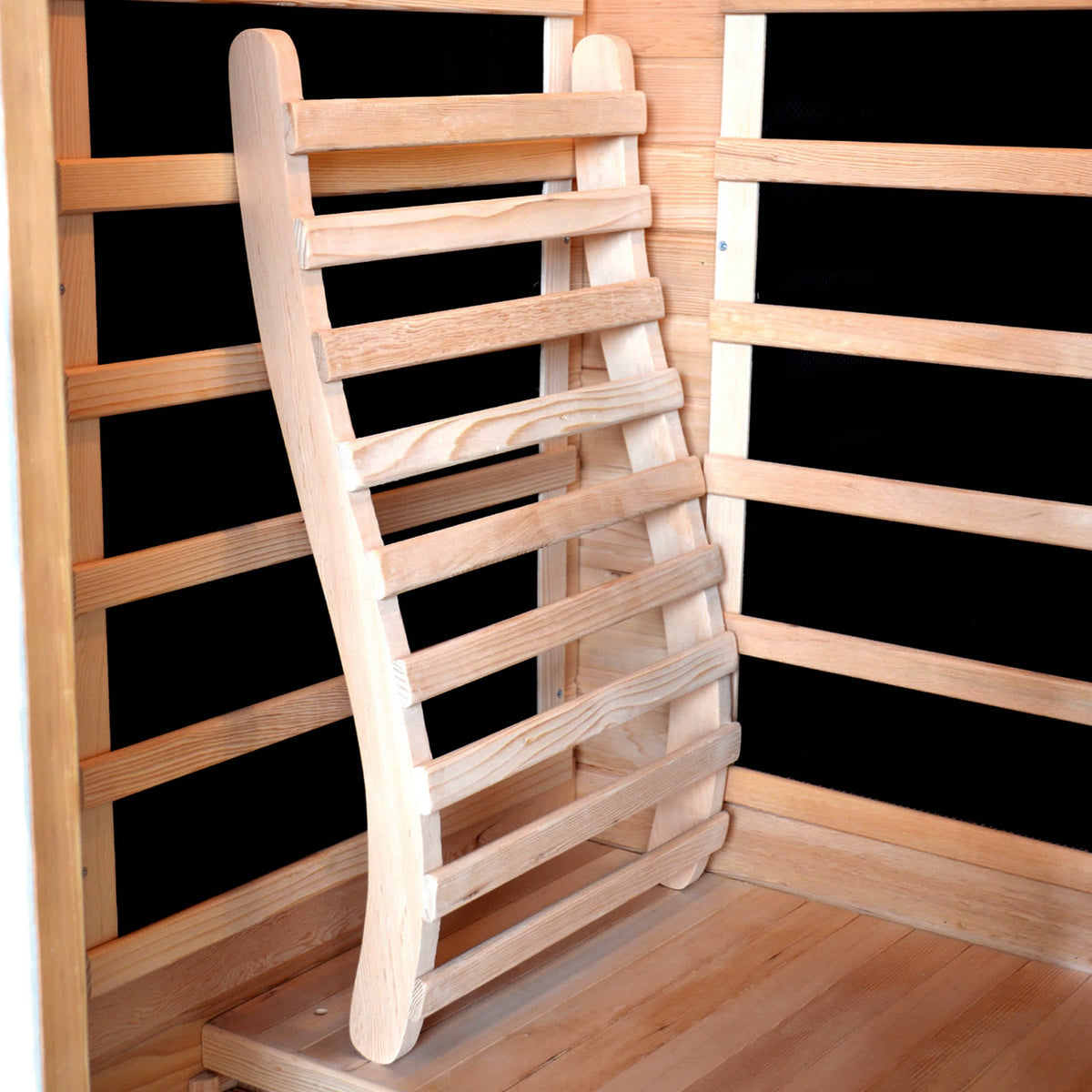 HeatWave Universal Sauna Backrest - curved backrest propped against the cabin wall slats