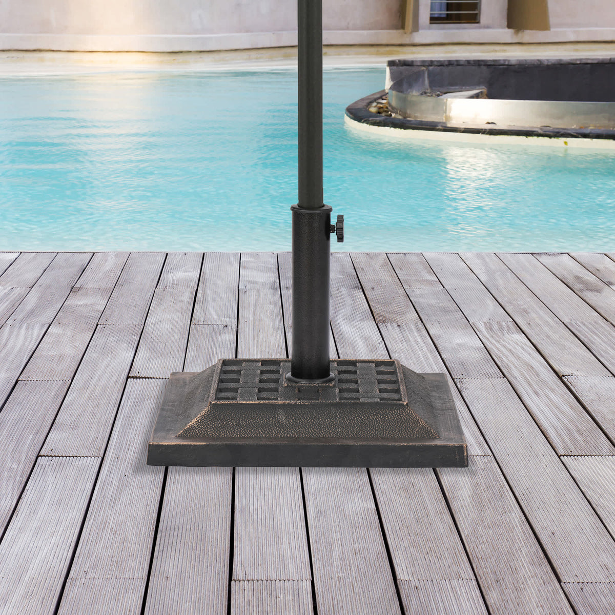 Island Umbrella 26-lb Square Base - bronze base holding a pole on a poolside deck
