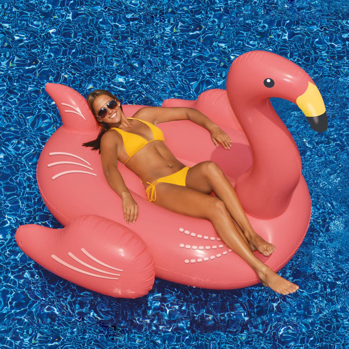Swimline Giant Pink Flamingo Float - swimmer reclining on the ride-on flamingo in a pool