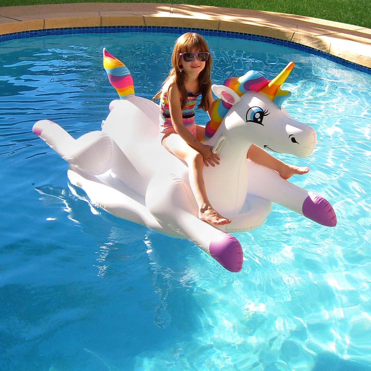 Blue Wave Cloud Rider Rainbow Unicorn Pool Float - child seated on the float, seen from the front
