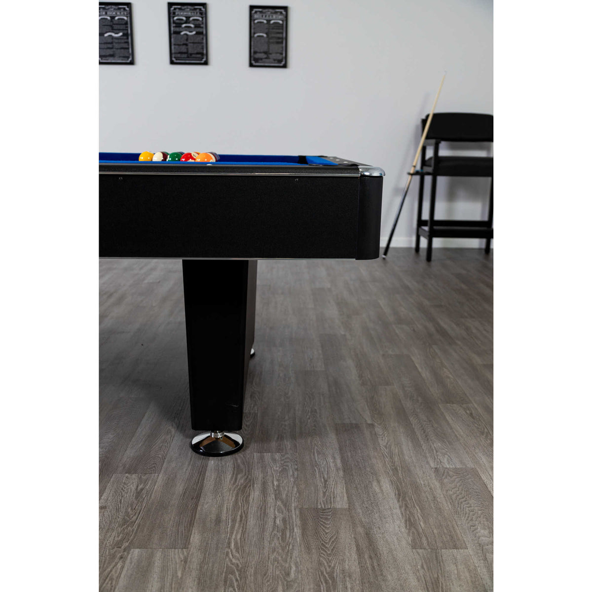 Hathaway Hustler Pool Table - table corner and leg in a games room with balls racked on blue felt