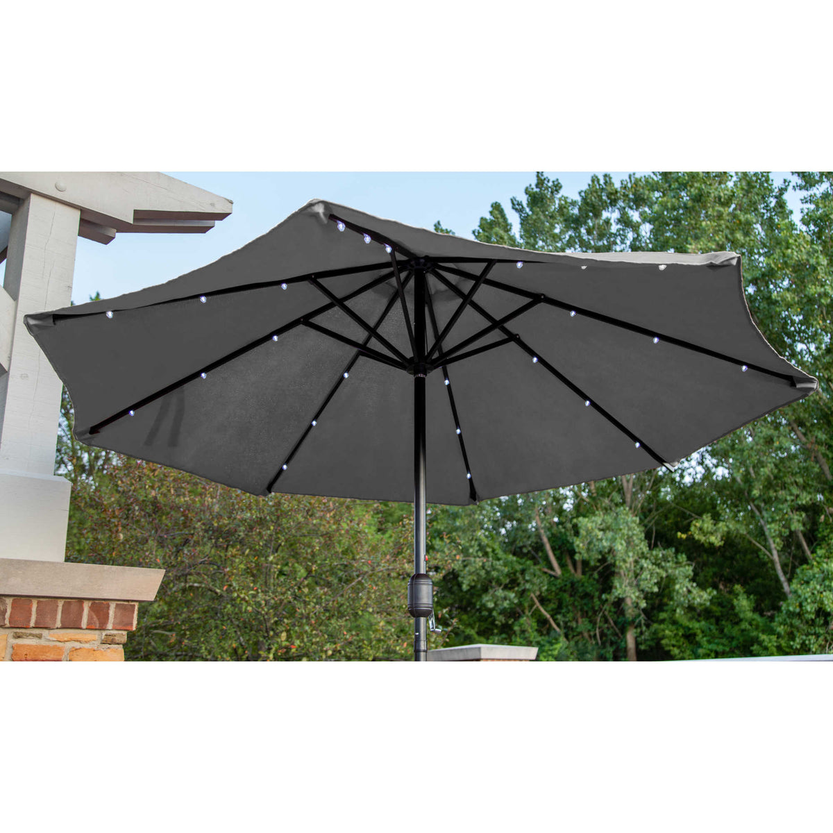 Island Umbrella Mirage Fiesta Umbrella - LED rib strips lit under the grey canopy at dusk