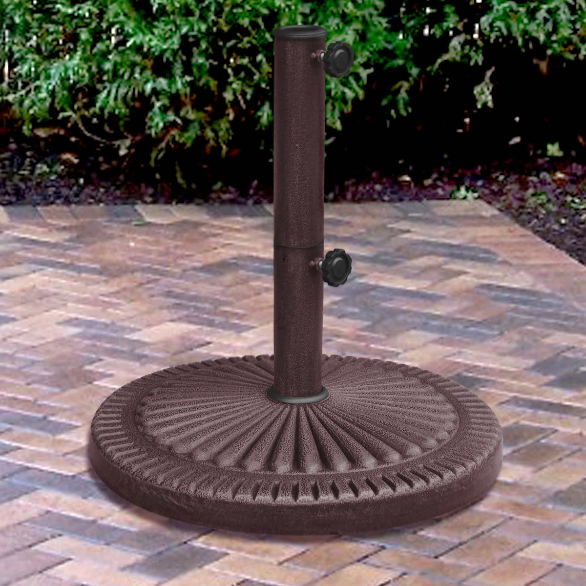 Island Umbrella 66-lb Base - fluted round base holding a pole on a block-paved patio