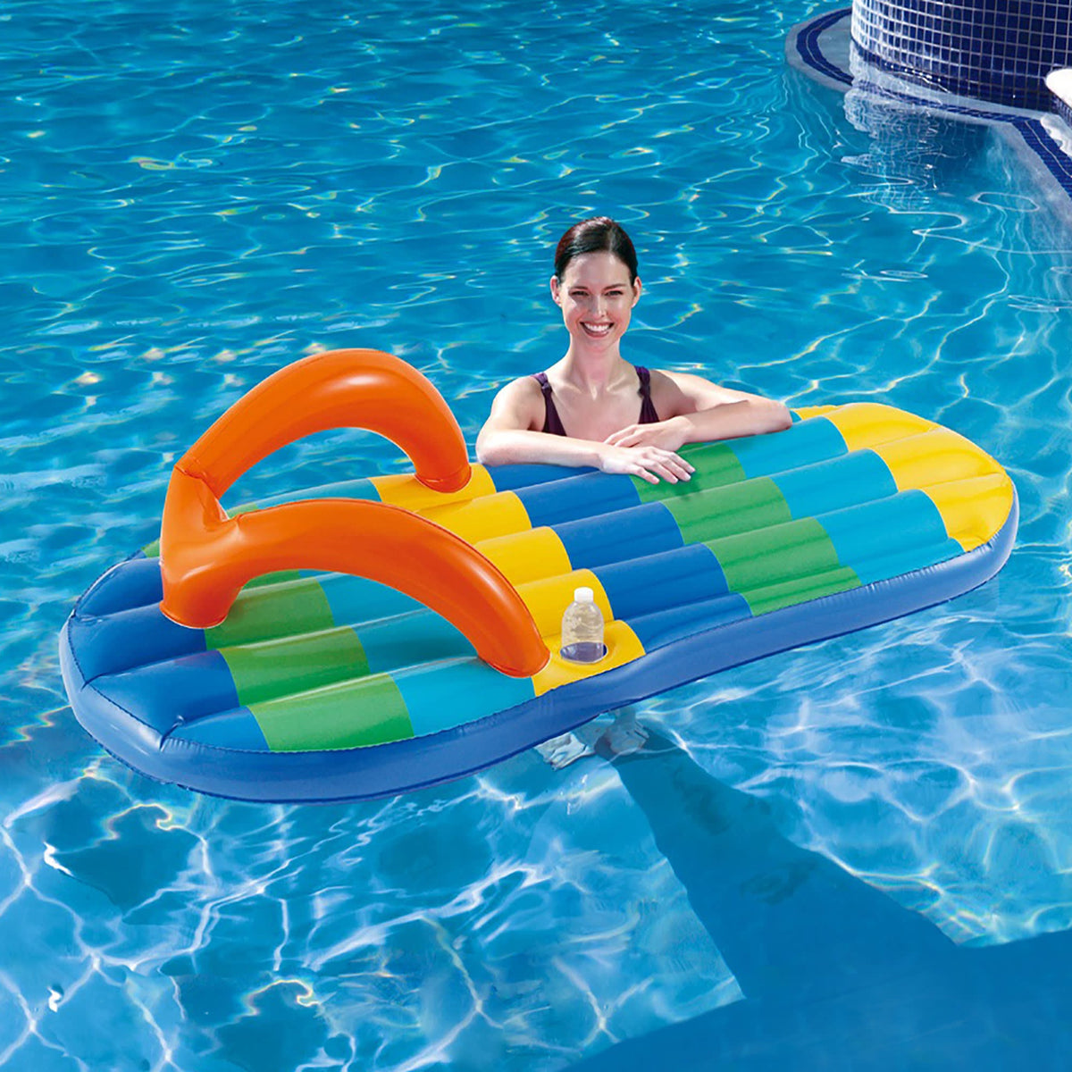 Blue Wave Beach Striped Flip Flop Pool Float - swimmer resting on the float in a pool