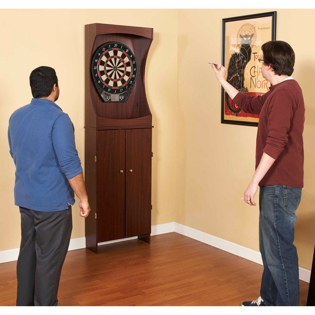 Hathaway Outlaw Dartboard Cabinet - two players throwing at the cabinet in a corner of a room