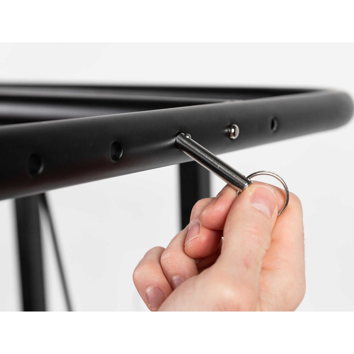 HeatWave Premium Cover Lift - hand inserting the locking pin through the adjustment bar