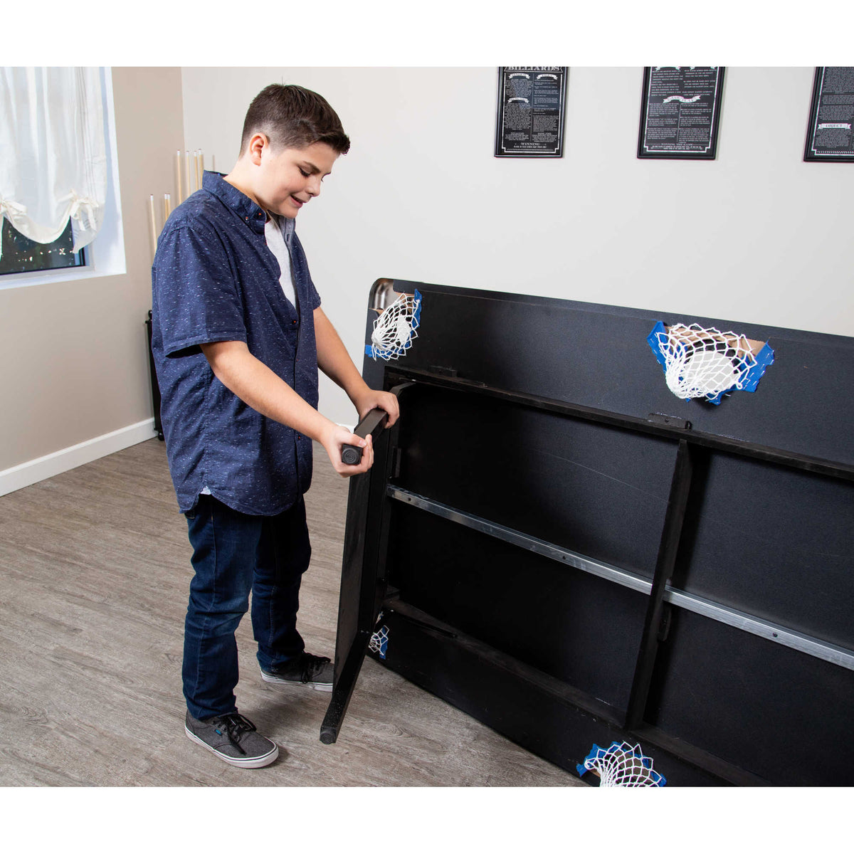 Hathaway Fairmont 6-ft Pool Table - folding a steel leg up under the table for storage