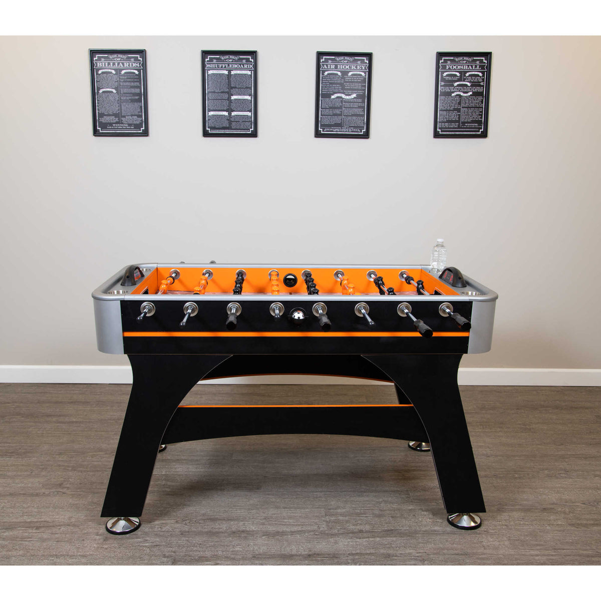Hathaway Game Rules Wall Art - the four prints hung in a row above a foosball table