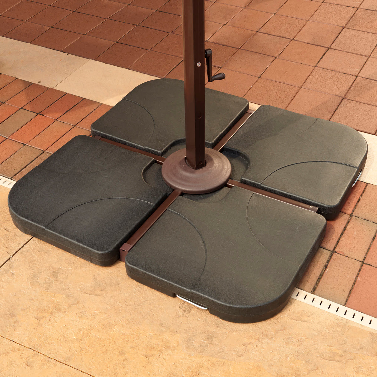 Island Umbrella 35-lb Base Weights - all four sections locked around a cantilever pole on a patio