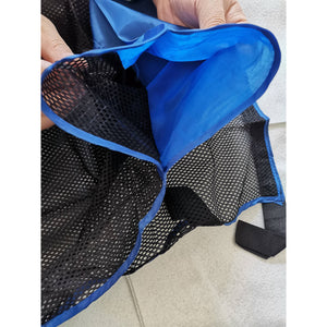 Blue Wave Noodlechair - blue-bound edge and open mesh seat panel held open by hand