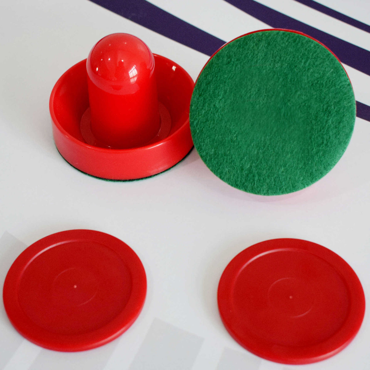 Hathaway Face-Off Air Hockey Table - red strikers showing the green felt base, with two pucks