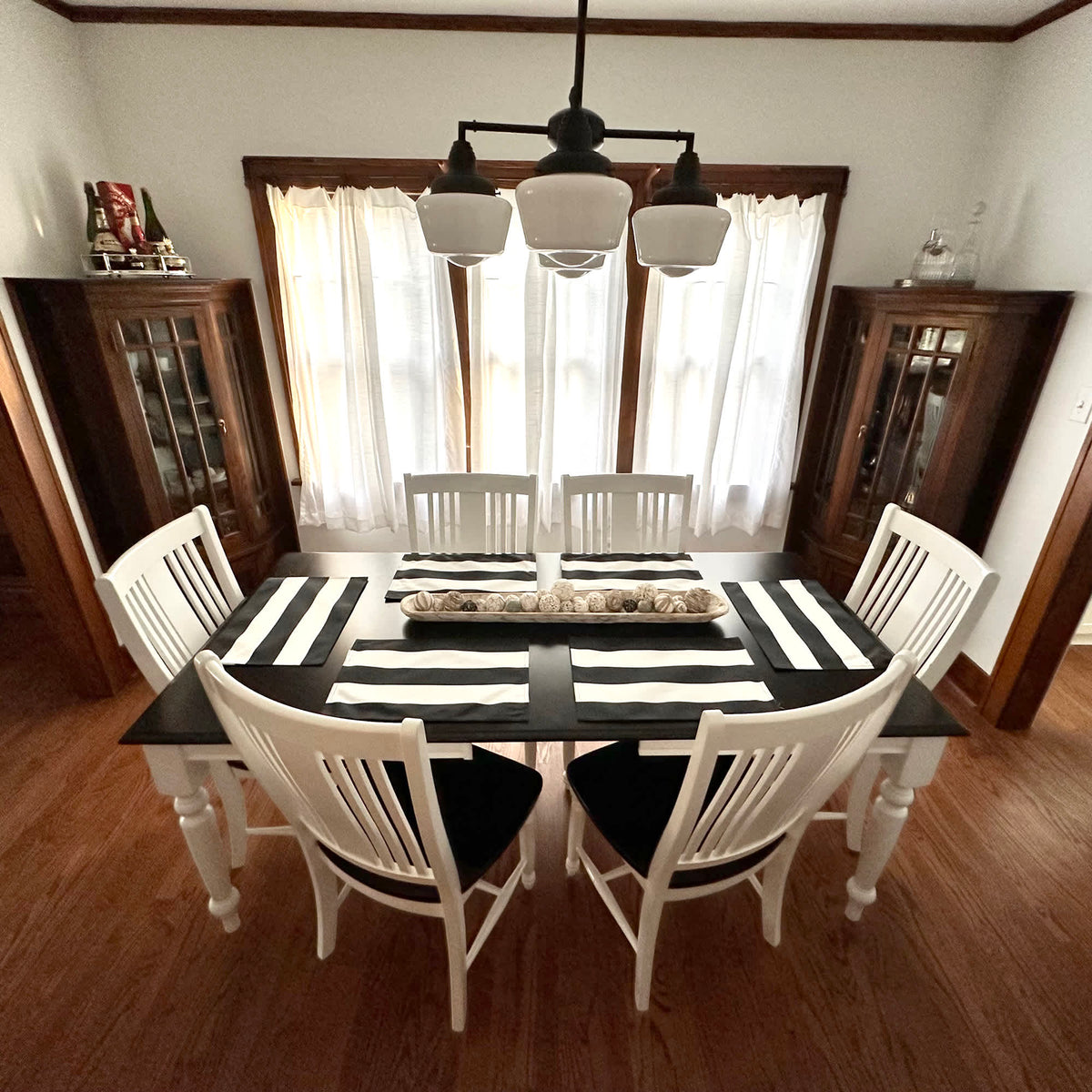 Island Retreat Outdoor Table Mat Set - striped mats and runner laid on a dark dining table
