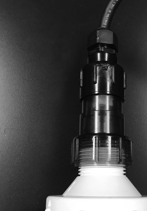 Solaxx Precision UV UV6000A chamber cap seated on the white union that joins the UV chamber to the manifold