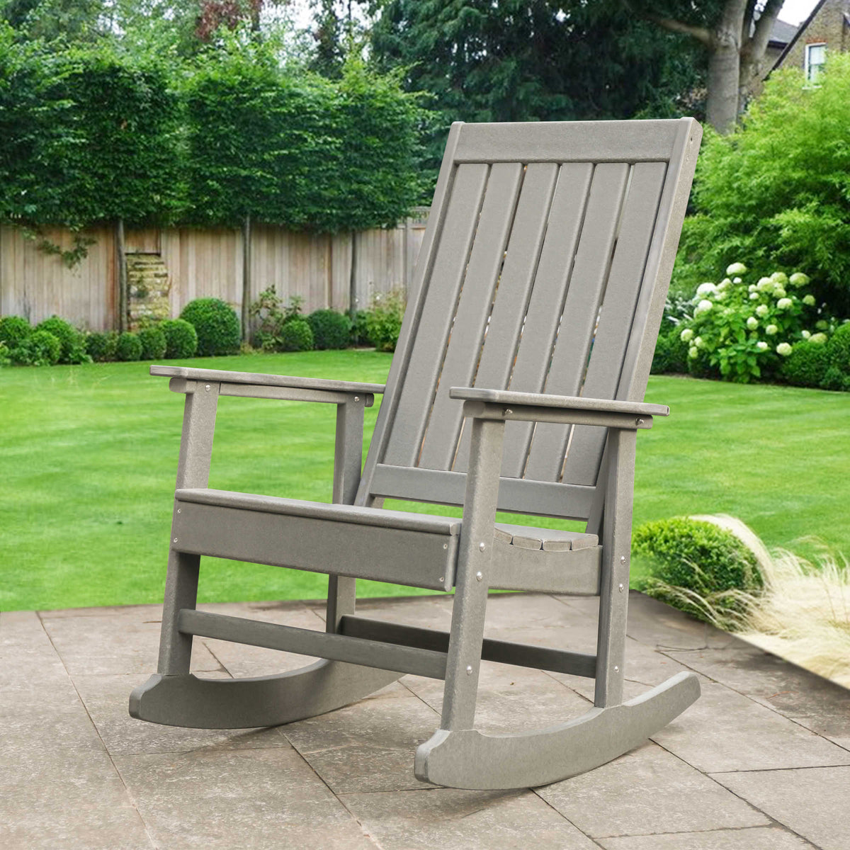 Island Retreat Adirondack Rocker, Slate Grey - rocker on a paved patio beside a lawn