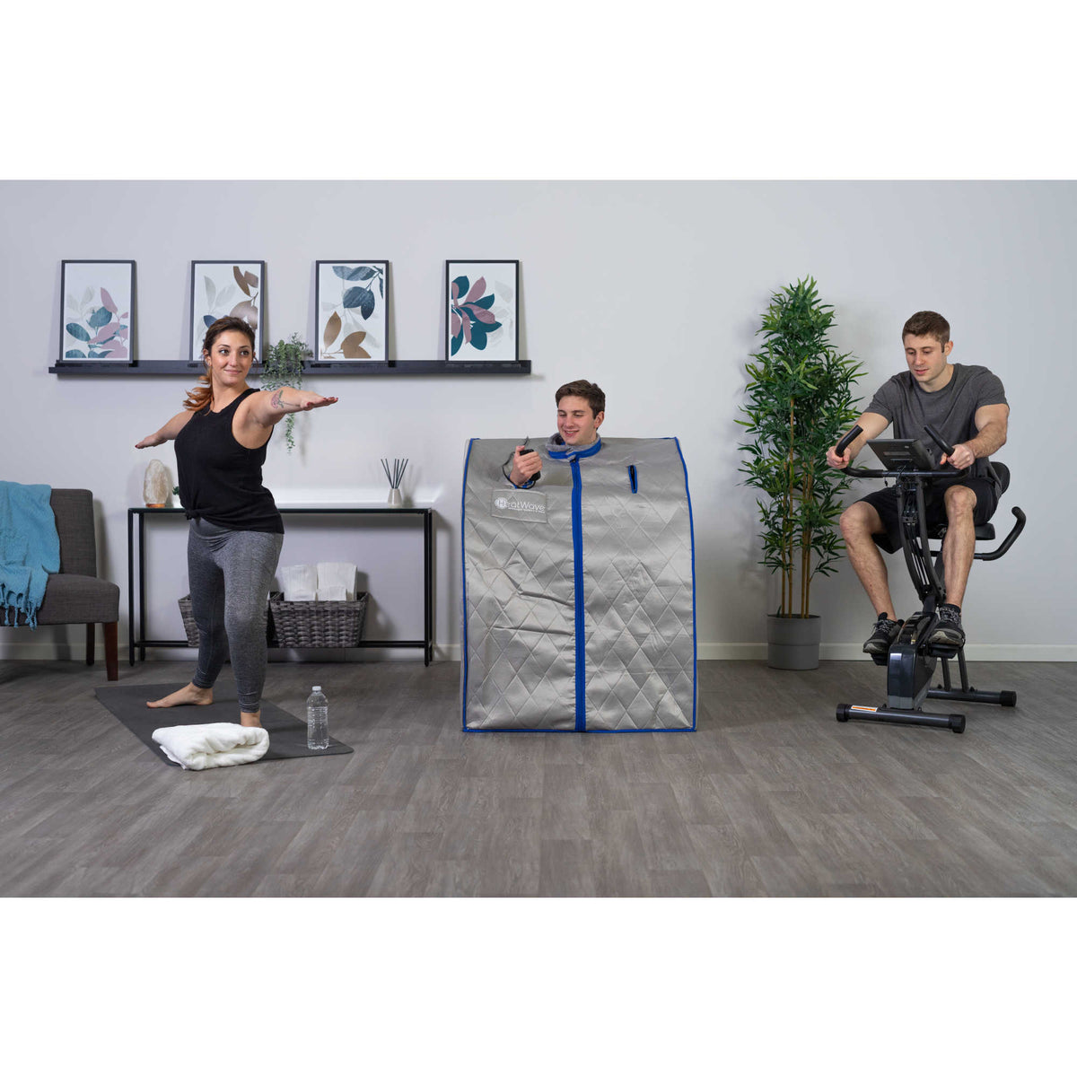 HeatWave Spirit Portable Sauna - user seated in the cabin in a home gym with others exercising