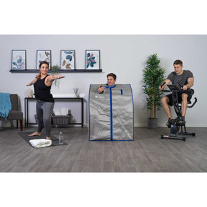 HeatWave Spirit Portable Sauna - user seated in the cabin in a home gym with others exercising