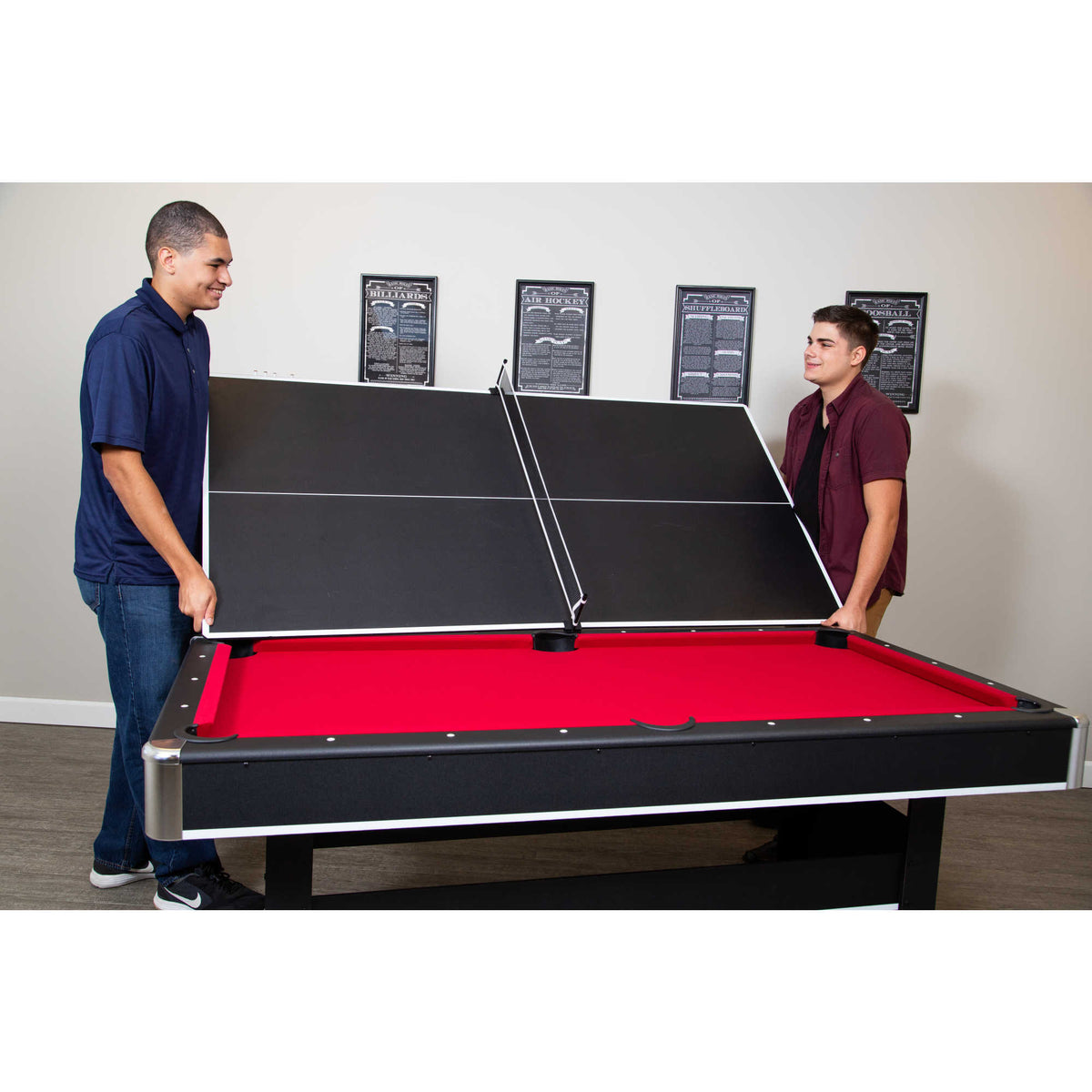 Hathaway Spartan 6-ft Pool Table - two people lifting the table tennis top onto the red felt bed