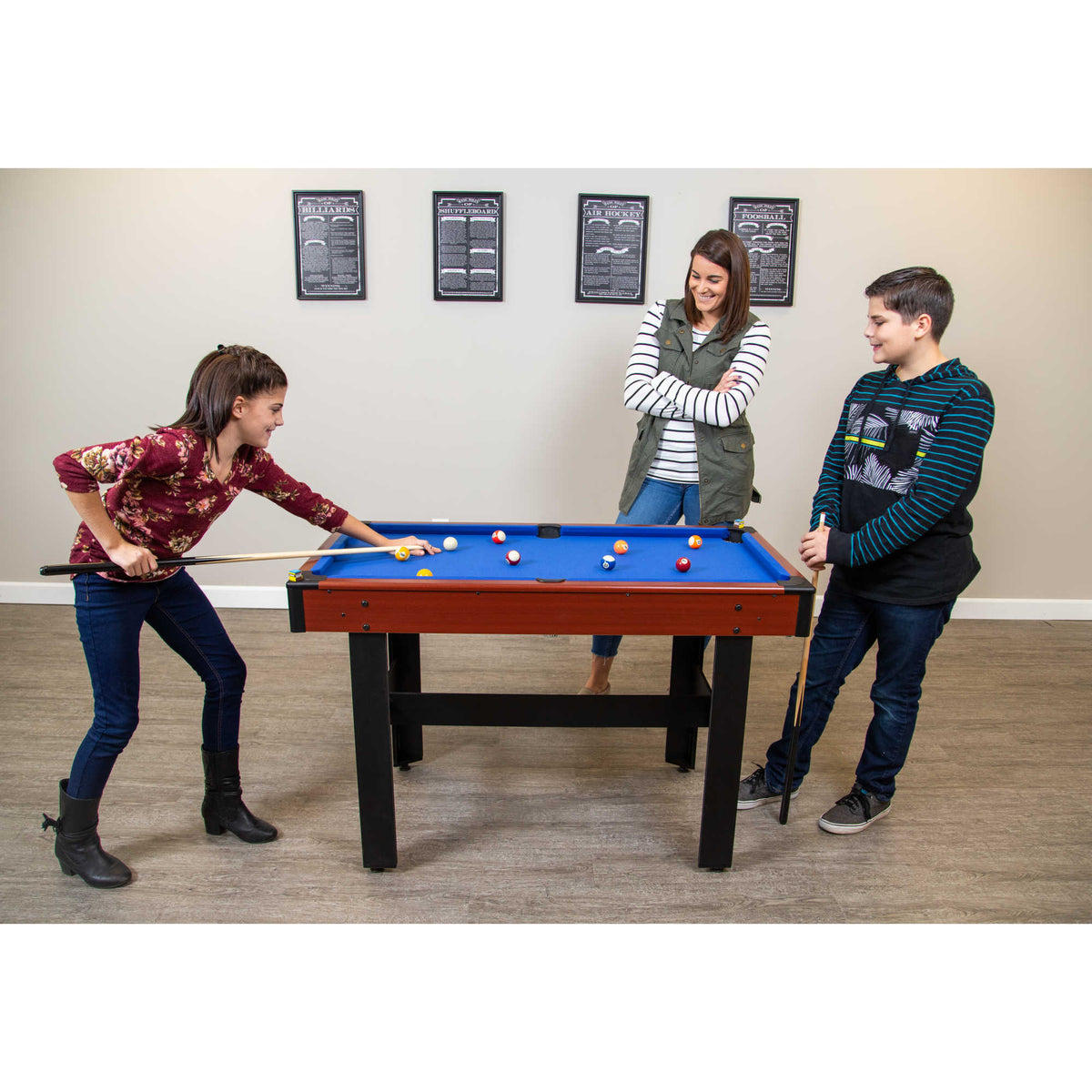 Hathaway Triad Multi-Game Table - three people around the table mid-frame of pool