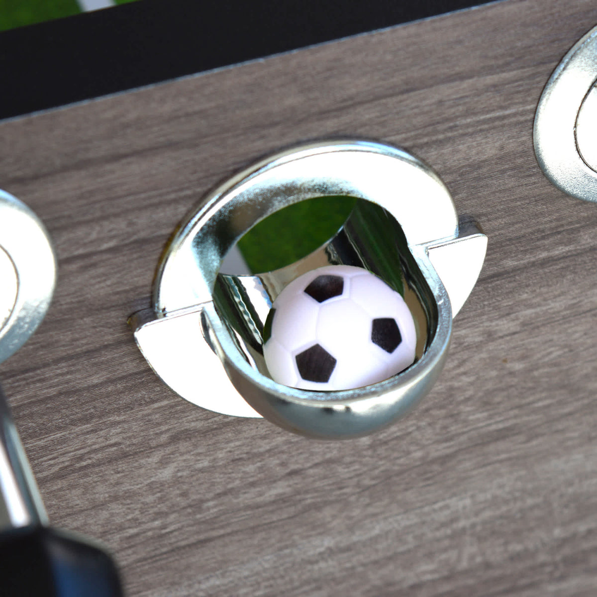 Hathaway Driftwood Foosball Table - chrome ball-return cup with a soccer ball inside