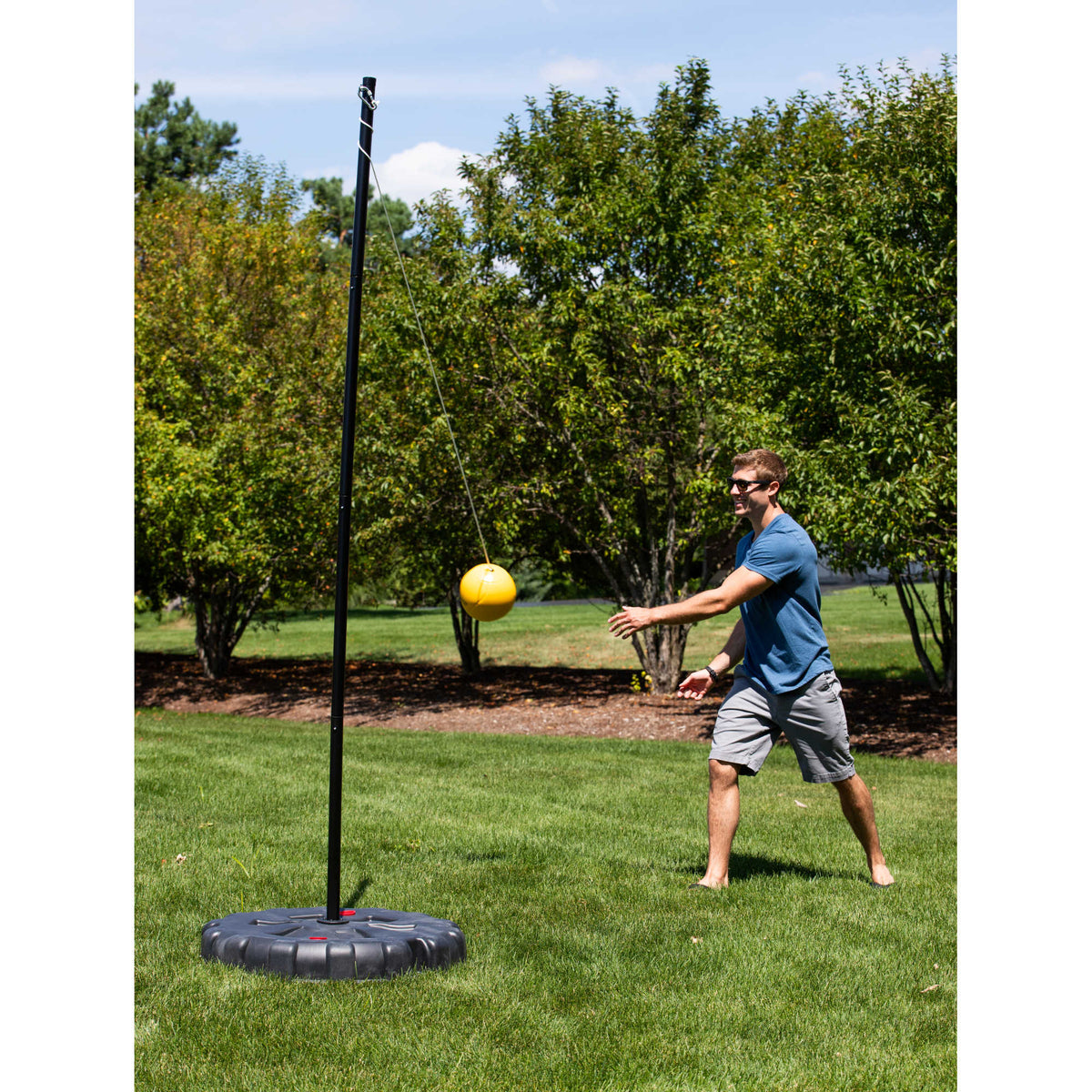 Hathaway Tetherball Set - player striking the ball as it swings around the pole